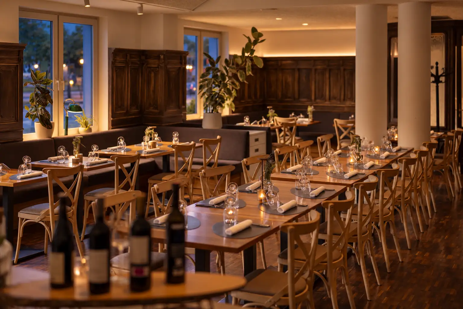 Elegant dining area in the restaurant with stylish tables, chairs, and candlelight, perfect for a relaxed meal.