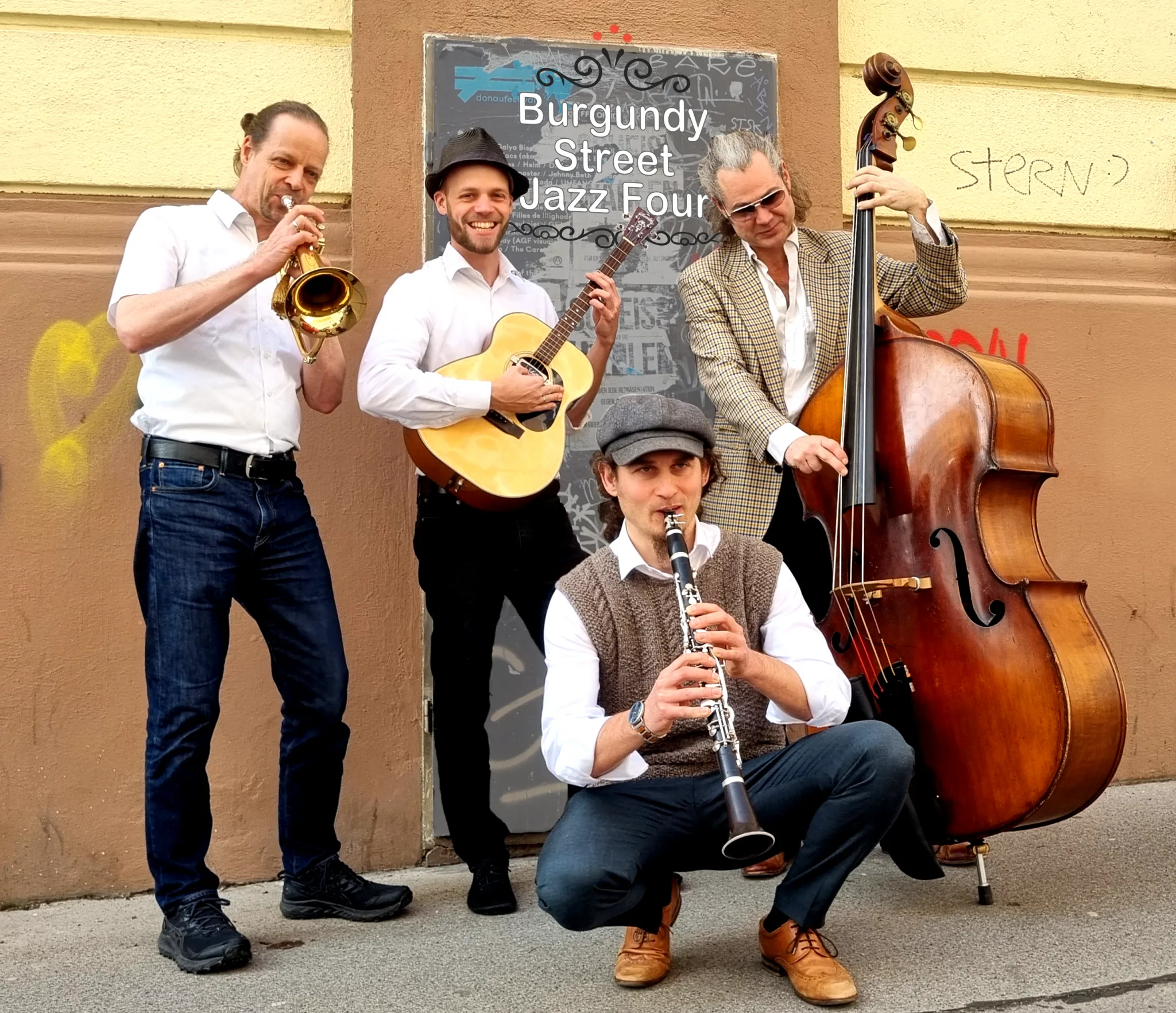 Four musicians playing jazz on the street with various instruments.