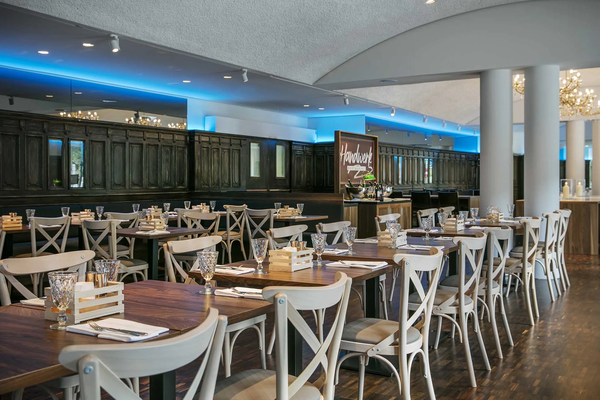 View of a modern restaurant with elegant tables and chairs.