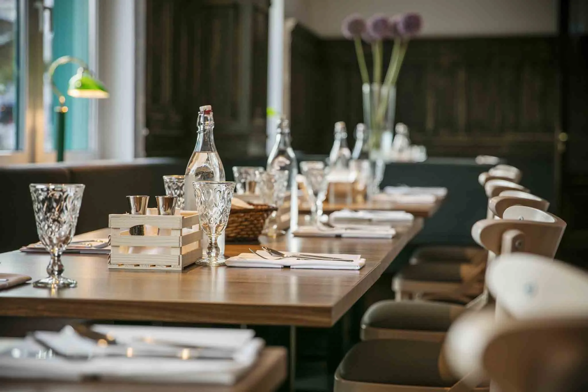 A beautifully set table with glasses and cutlery in a restaurant.