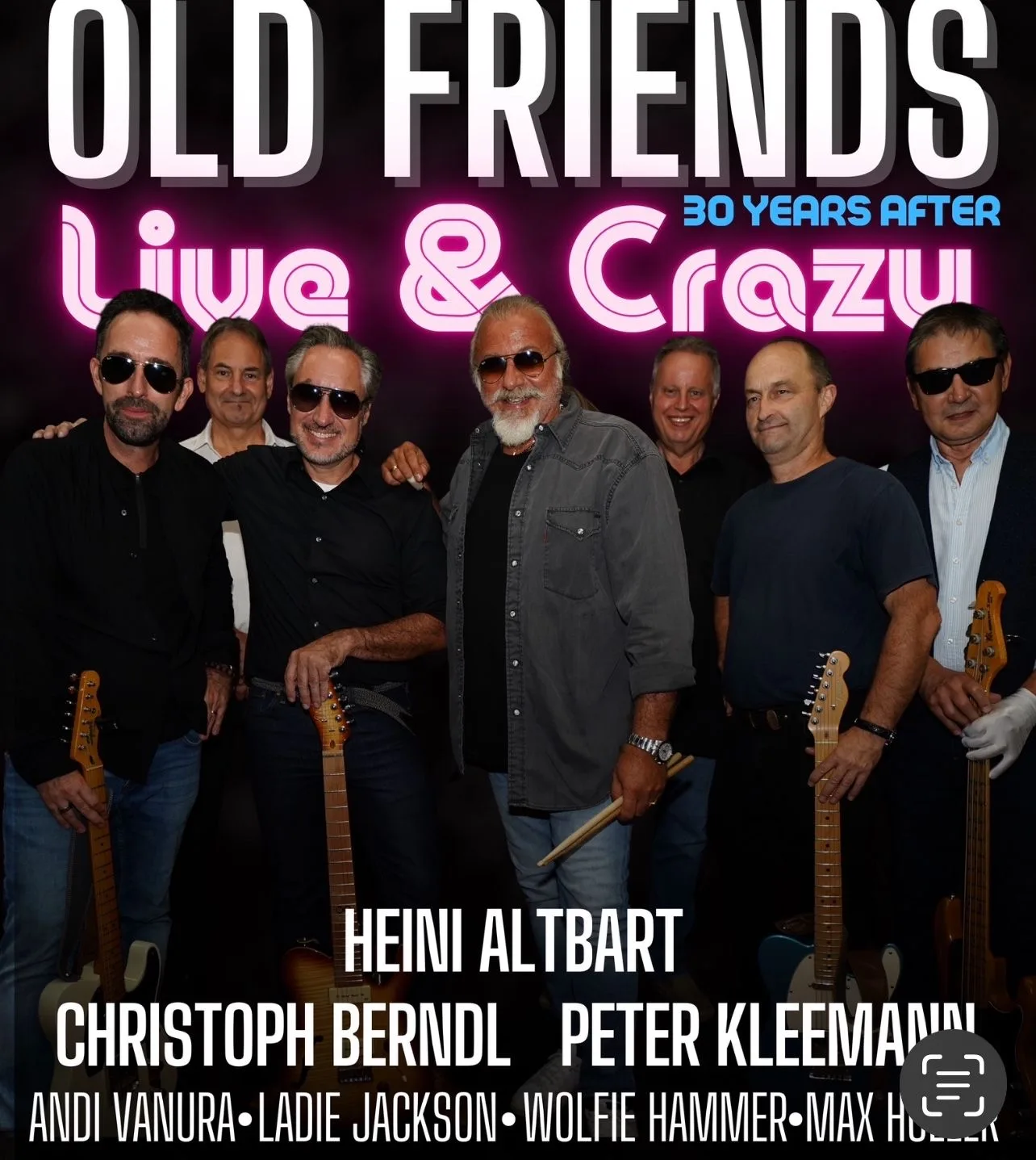 Group of musicians at a concert with guitars and sunglasses.