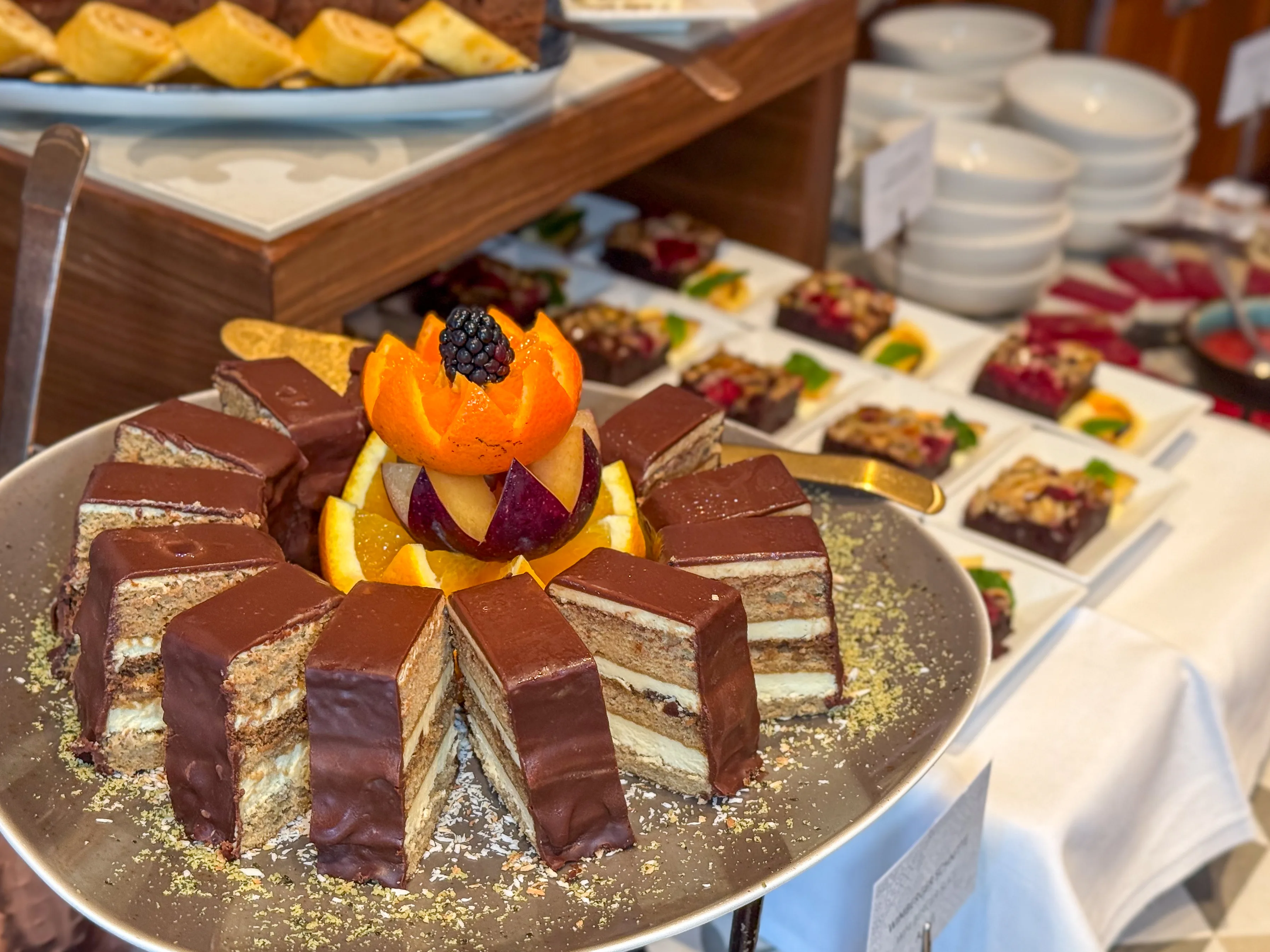 A beautifully decorated chocolate cake with fresh fruits.